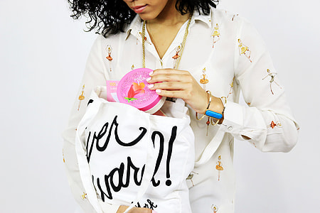 woman wearing white dress shirt  holding white tote bag thumbnail
