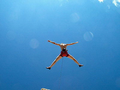 man wearing red shorts with black harness while bungee jumping thumbnail