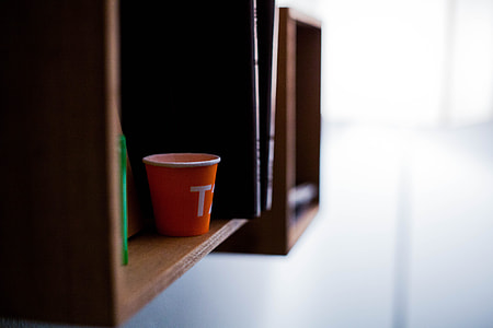 red plastic cup on wall shelf thumbnail