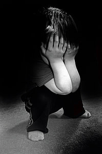 grayscale photo of boy in black pants face palming thumbnail