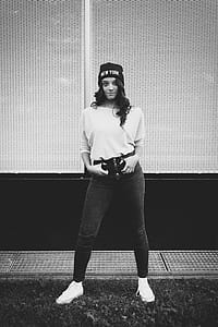Grayscale Photography of Woman Standing in Front of Building thumbnail