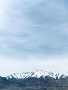 mountain covered by snow under white clouds at daytime thumbnail