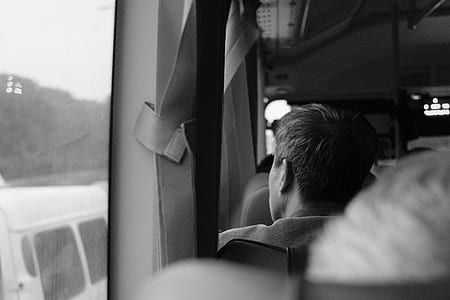 grayscale photography of man inside vehicle thumbnail