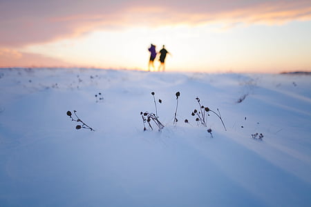 two people standing on land covered in snow thumbnail