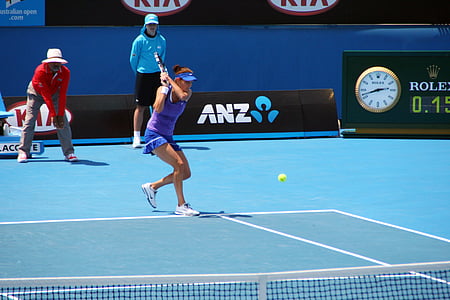 woman playing tennis in court thumbnail