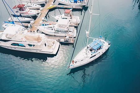 boat sailing near parked boat during daytime thumbnail