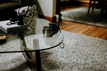 black camera body beside white jar on table thumbnail