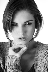 grayscale photo of woman in knitted long-sleeved top thumbnail