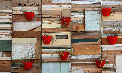 red planters with plants on wall thumbnail