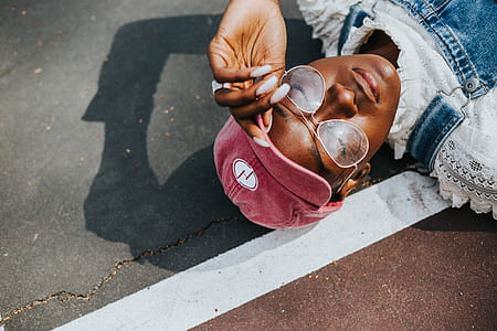 person lying down on concrete floor holding his cap thumbnail