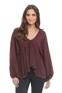 woman wearing brown V-neck long-sleeved blouse and black pants thumbnail