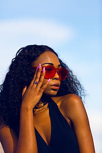 person in red sunglasses and black dress thumbnail