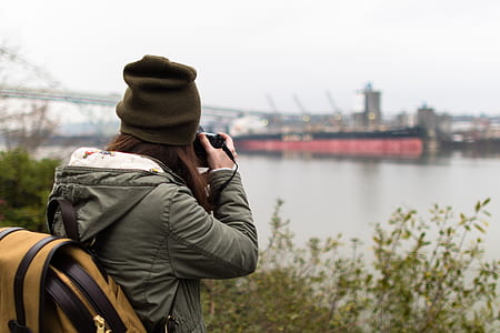 woman taking photo of ship thumbnail