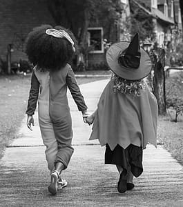 Grayscale Photography of Two Children Holding Hands Together thumbnail