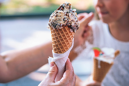 selective focus photography of sugar cone with chocolate ice cream and peanuts on top thumbnail