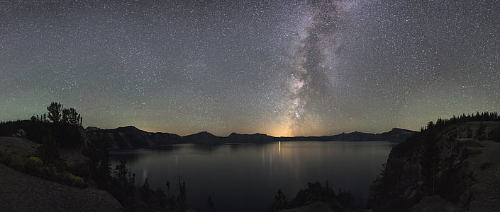 body of water near tree during nighttime thumbnail