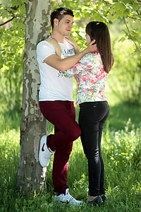 man and woman standing near tree thumbnail