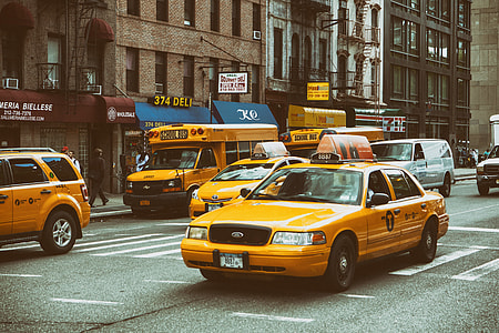 Yellow taxis and buses on the streets on Manhattan, New York City thumbnail