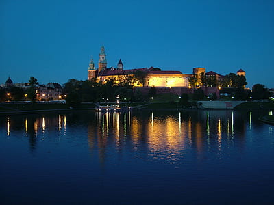 lighted brown castle near calm body of water thumbnail