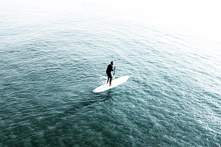 man riding on his white surfboard thumbnail