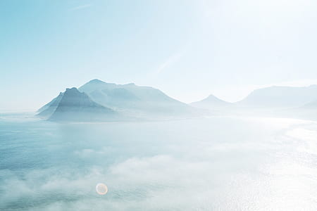 photo of mountains on body of water thumbnail