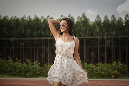 woman standing in front of green trees thumbnail