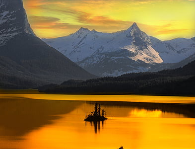 silhouette of plant surrounded with body of water near snow covered mountains during sunset thumbnail