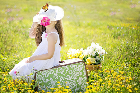 girl wearing white sleeveless dress sitting on green bag thumbnail