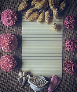 black-line paper between of assorted petaled flowers thumbnail