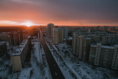 aerial shot of high-rise buildings under golden sky thumbnail