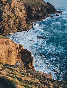 sea waves hitting rock cliffs thumbnail