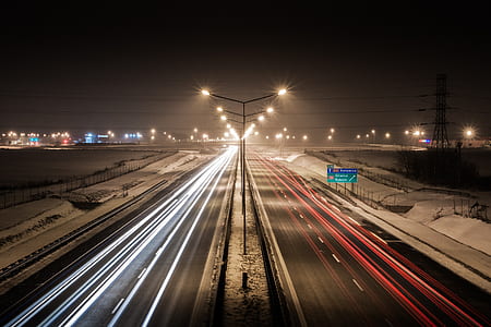 time lapse photography of moving vehicles on highway during night time thumbnail