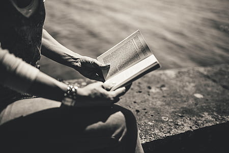person in black top holding a book thumbnail