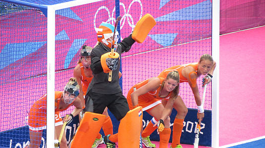 man and four women standing beside goalie thumbnail