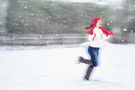 woman in white coat with red scarf with brown boots on snow thumbnail
