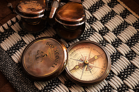 white compass on white textile thumbnail