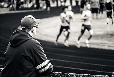 grayscale photography of man watching at runners thumbnail