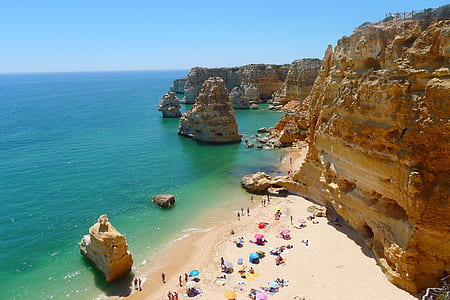 group of people at seashore beside cliff thumbnail
