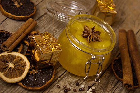photography of yellow gel candle on brown wooden table thumbnail