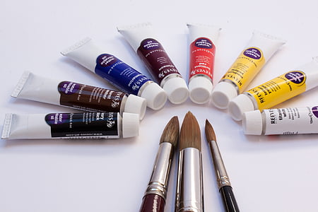eight assorted water color tube bottles beside three paint brushes thumbnail