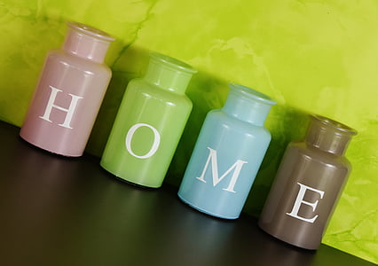 four ceramic jars near green wall thumbnail