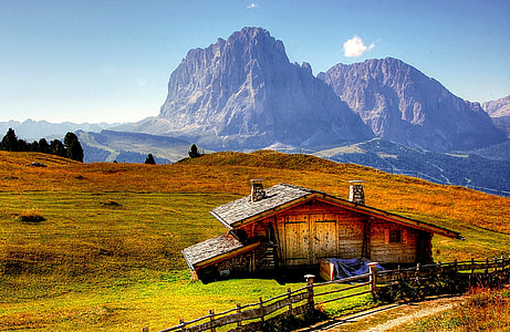 landscape photography of brown wooden house beside wooden fence thumbnail