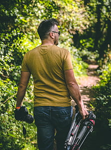 man wearing brown shirt holding gimbal thumbnail