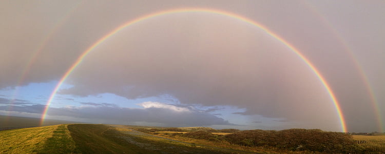 green land with rainbow on sky thumbnail