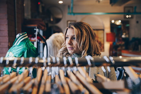 Woman Within Clothing Racks Photo thumbnail
