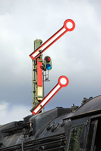 black locomotive train passing through toll gate during daytime thumbnail