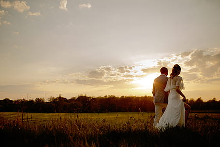 couple walking on grass field thumbnail