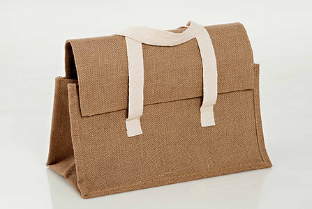 brown and white canvas handbag on white surface thumbnail