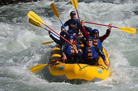 men sailing kayak while holding paddles thumbnail