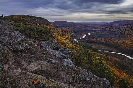 brown rock mountain near river thumbnail